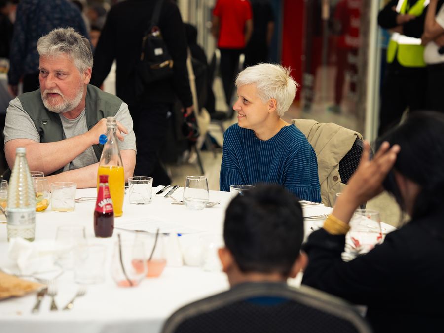Guests in conversation at a community dinner event